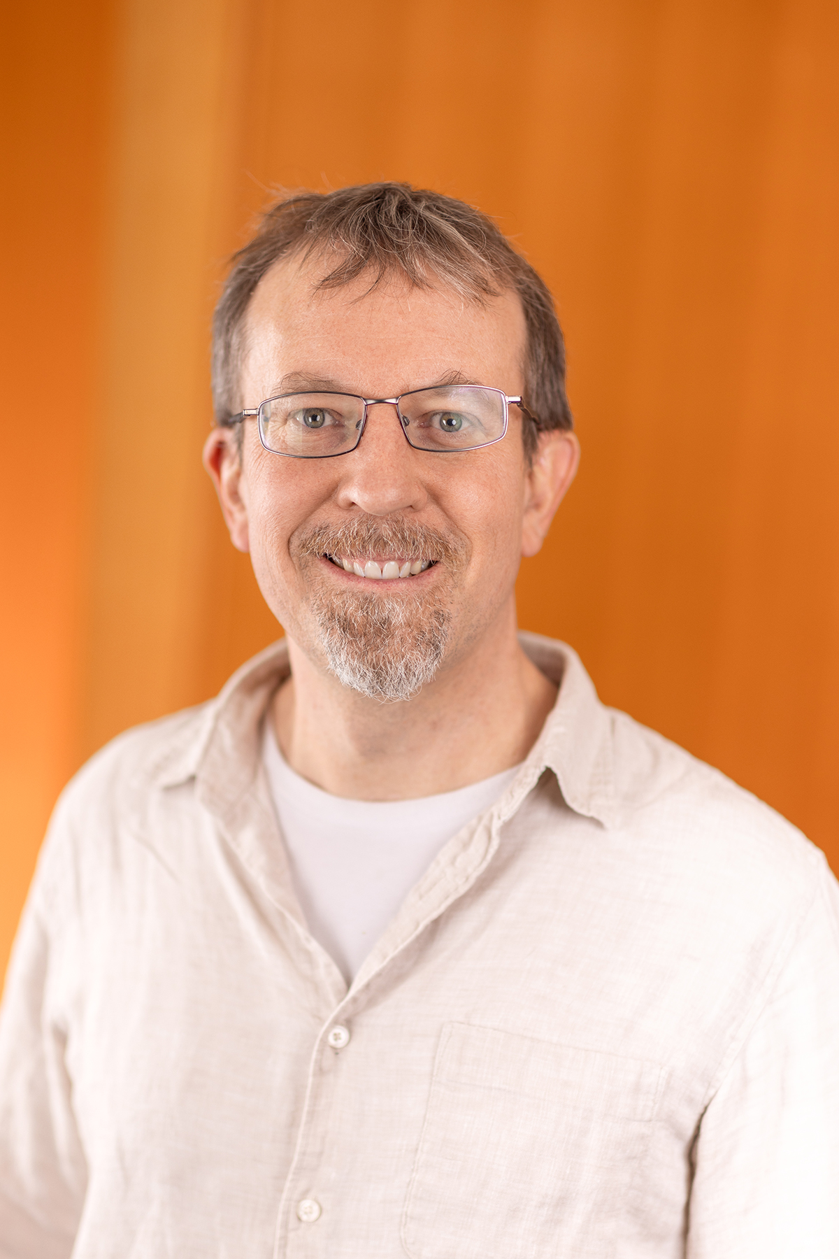 Head shot of Professor Mark Nitz, a white man with a beard and moustache, wearing glasses and a white shirt.