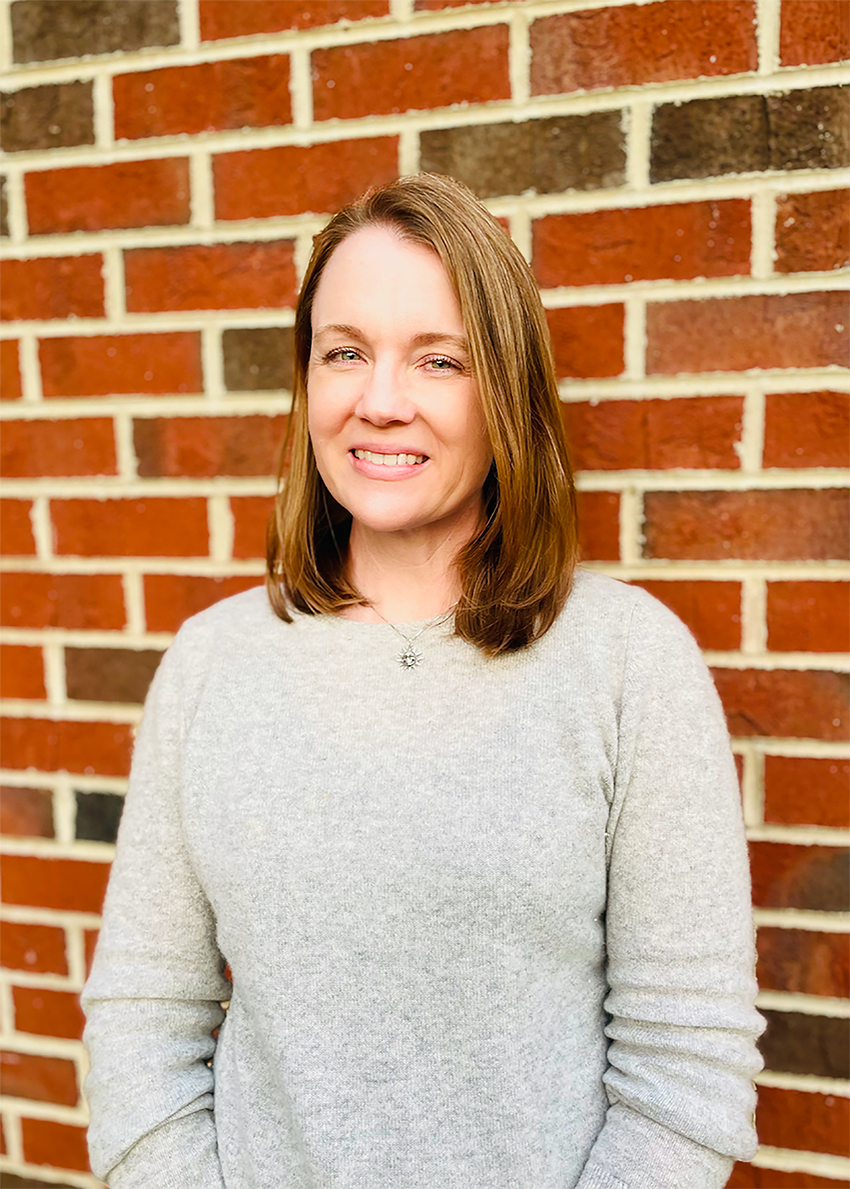 Head shot of Professor Amanda Hargrove, standing in front of a brick wall.