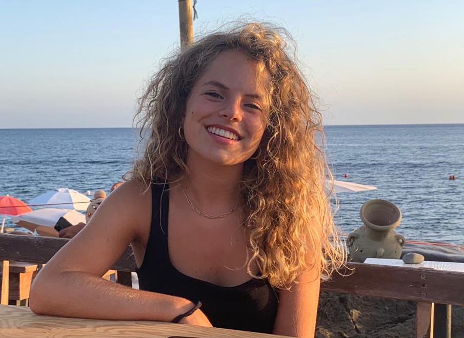 Portrait of a young white woman with the sea as a backdrop.