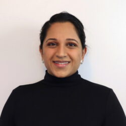 Head shot of Dr. Nimrat Obhi, a young brown person wearing a dark shirt.