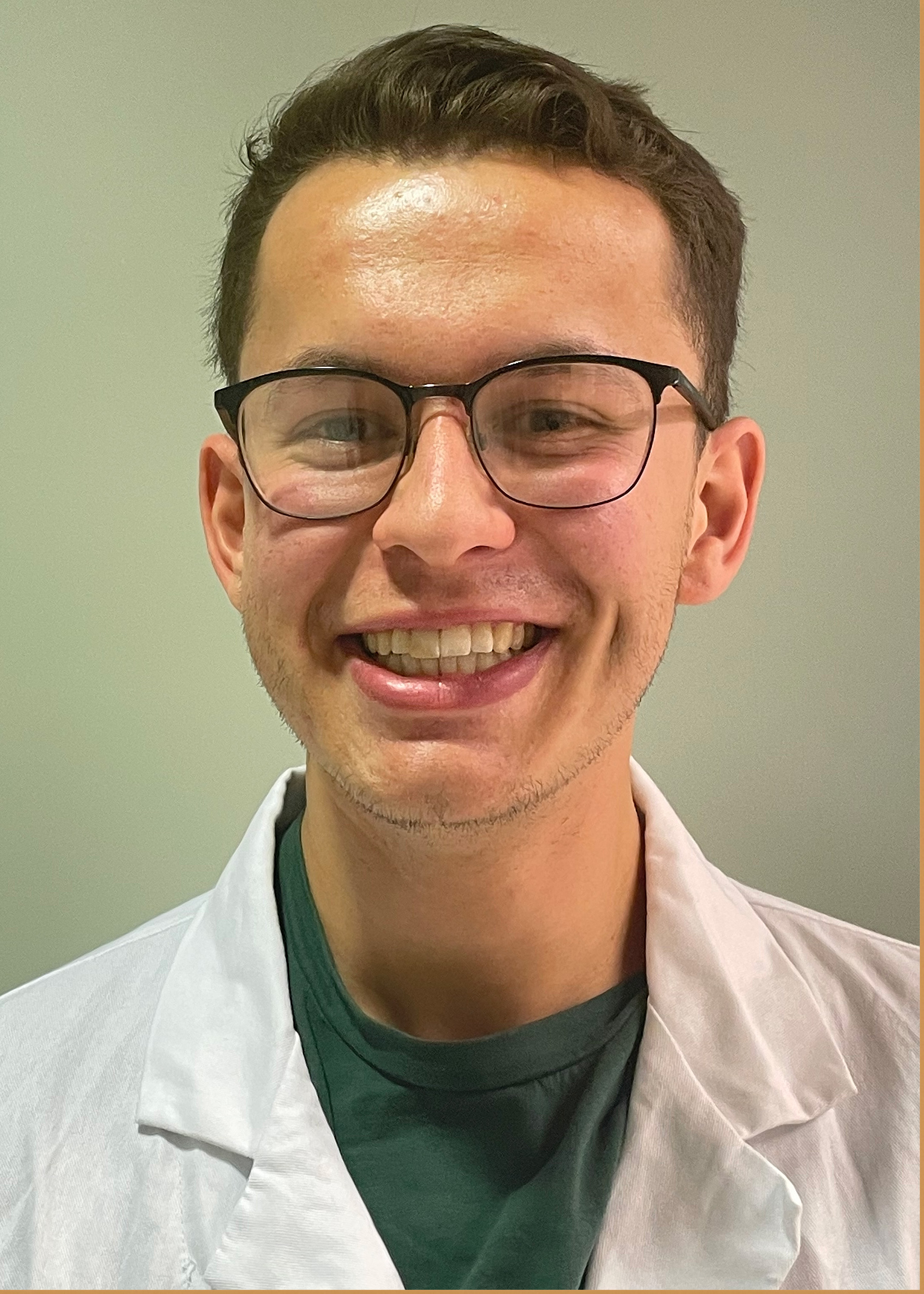 Head shot of Owen Vander Meulen, a young white man in a lab coat, wearing glasses